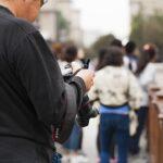 man checking his DSLR camera