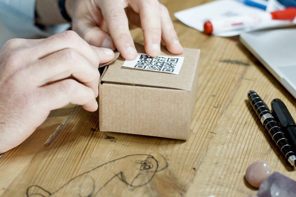 Person Holding Brown Cardboard Box