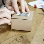 Person Holding Brown Cardboard Box