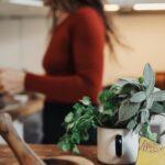 woman in red long sleeve shirt sitting by the table