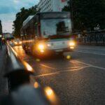 white bus on road at night