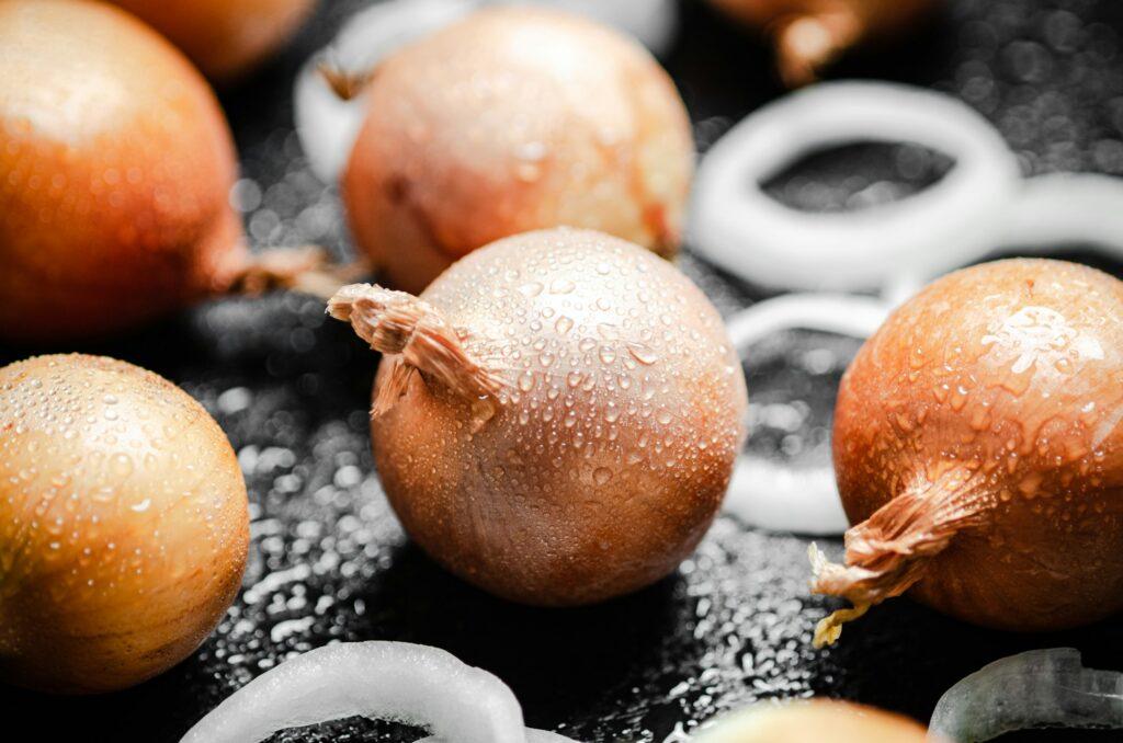 Fresh onions . On table