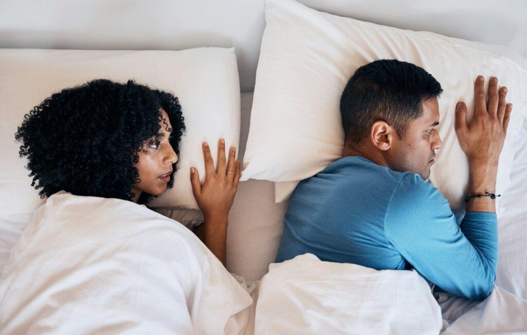 Frustrated couple, fight and lying in bed conflict, divorce or argument from disagreement or disput