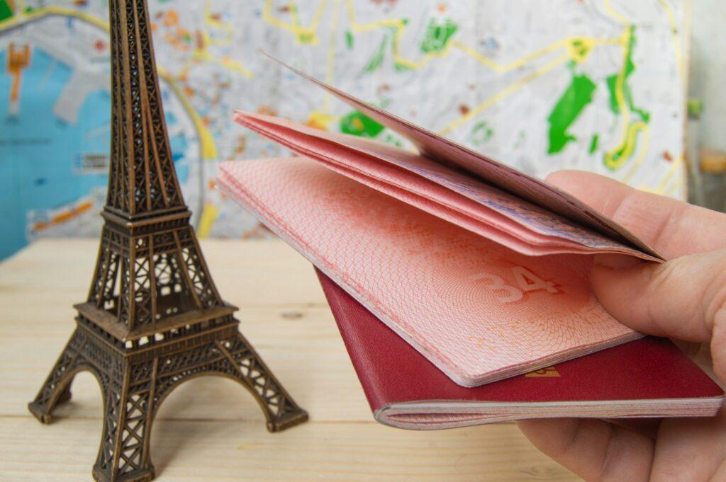 Passport in hand for trip, travel, journey. On map background