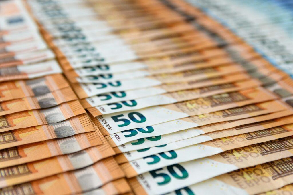 Selective focus of euro banknotes on table. Money, currency, cash, banking, finance.