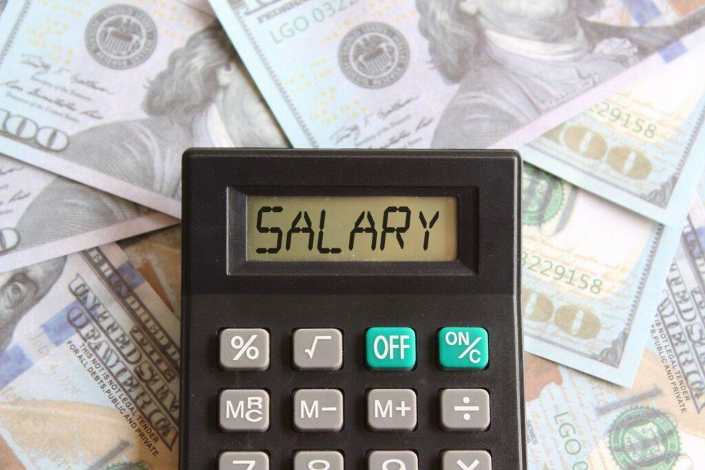 Top view image of calculator with text SALARY and money