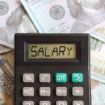 Top view image of calculator with text SALARY and money