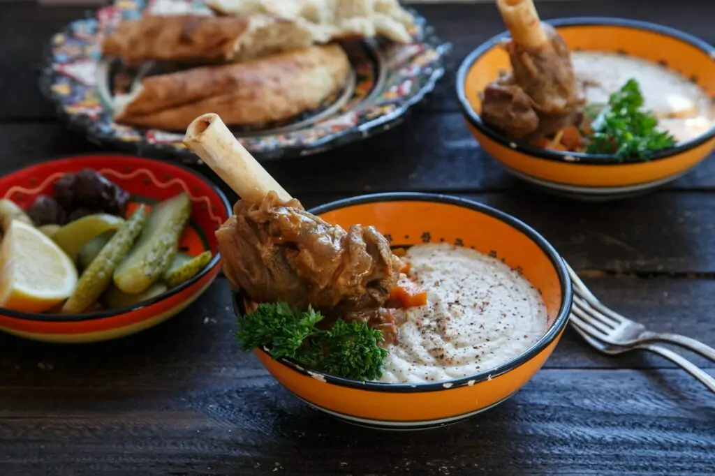 Lamb shank with puree and parsley in bowl