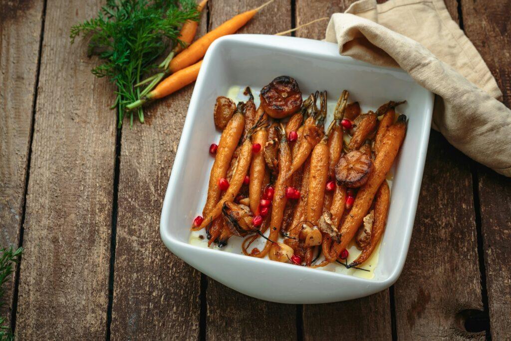 Roasted baby carrots with garlic and oregano, copy space