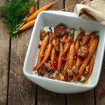 Roasted baby carrots with garlic and oregano, copy space