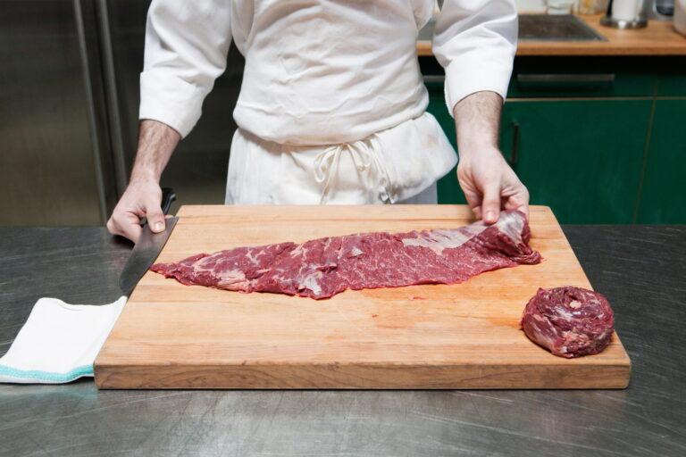 Butcher preparing beef tenderloin