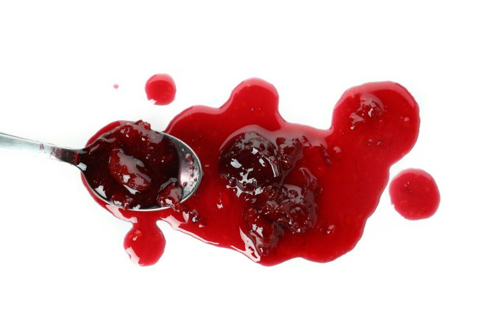 Tasty cherry jam isolated on white background