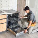 Worker repair dishwasher at home.