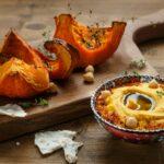 Pumpkin hummus and roasted butternut squash on background