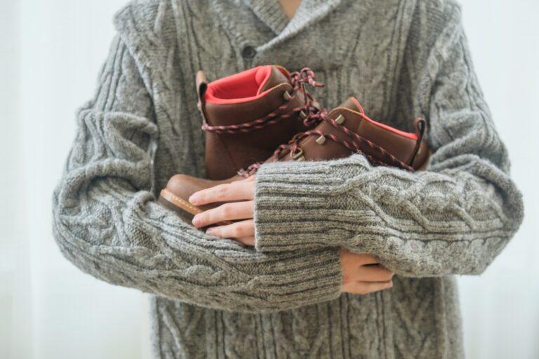 New womens leather brown waterproof winter boots in hands of female