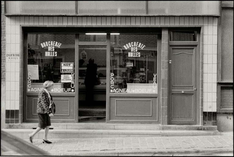 Timeless street scene featuring a classic butcher shop facade in black and white.