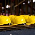 Several bright yellow hard hats are neatly lined up.