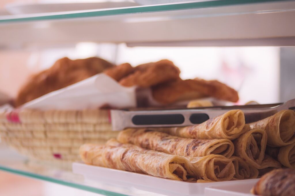 Présentoir alléchant de pâtisseries fraîchement cuites sur une étagère, parfait pour les gourmets.