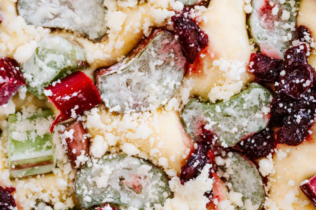 Vue détaillée d'un dessert garnie de rhubarbe colorée et de streusel.
