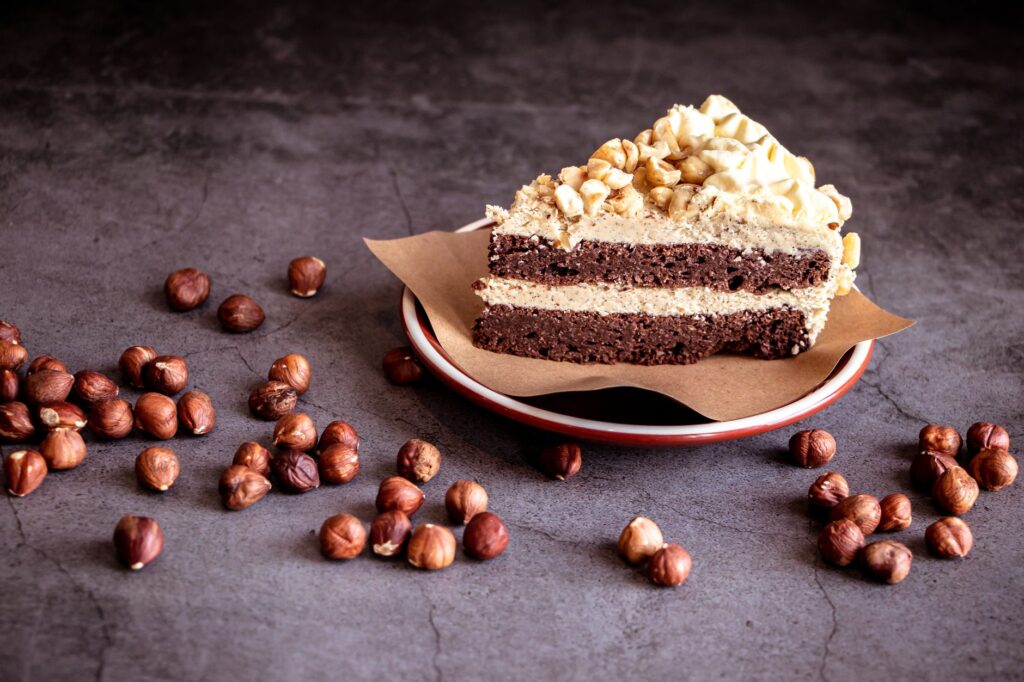 Savourez cette délicieuse part de gâteau au chocolat et aux noisettes, parfaite pour les amateurs de desserts.