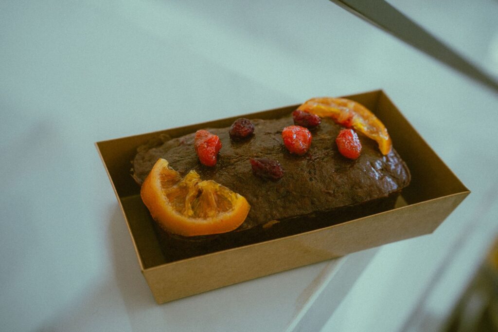 Un délicieux pain au chocolat garni de tranches d'agrumes et de baies, parfait pour le dessert.