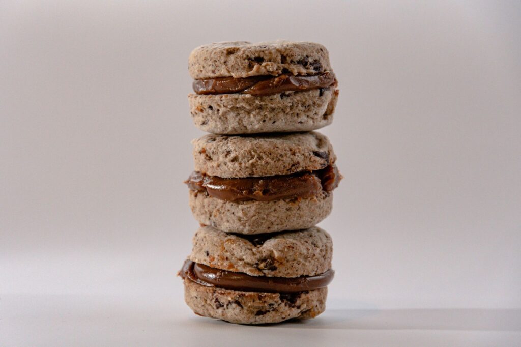 Une pile de délicieux macarons fourrés au chocolat avec une garniture crémeuse.
